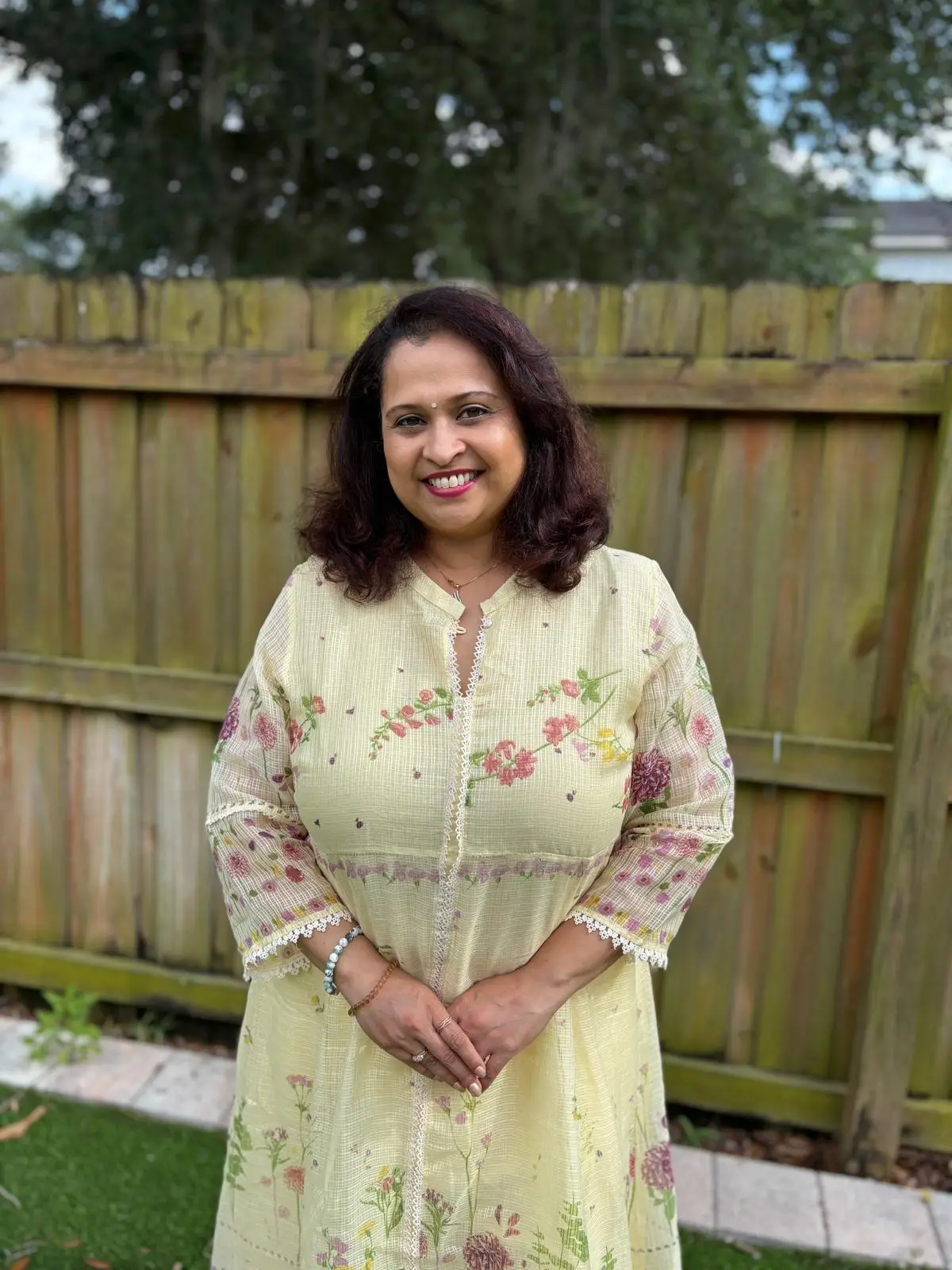 Ashwini Katre-Kulkarni, co-founder of Manaswini Arts, smiling in a pale green floral kurta.